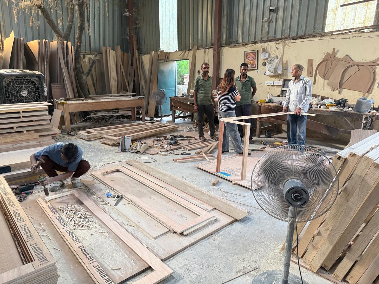 Carpenters working on furniture frames and panels